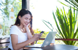 Women are selling products through social media using online notebooks at coffee shops.